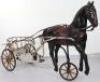 A very rare and early French pressed steel child’s pedal horse and trap, circa 1900