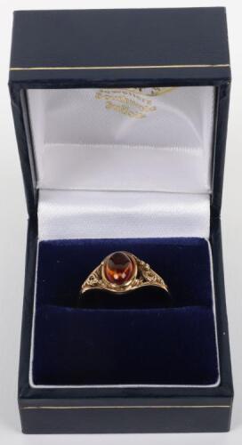 A 9ct gold and amber single stone ring