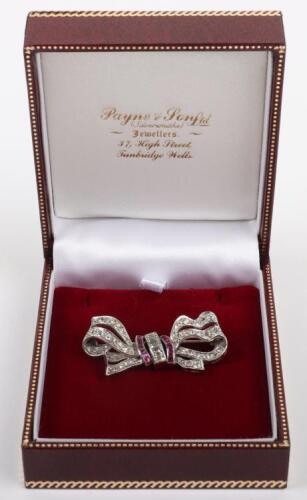 A white metal, diamond and ruby bow brooch