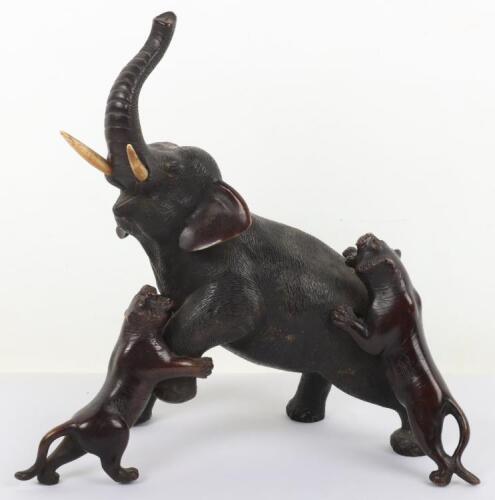 A Japanese Meiji period bronze group of anelephant being attacked by two tiger&rsquo;s