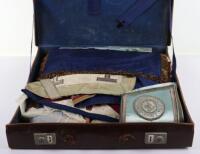 A leather suitcase of Masonic regalia, including aprons, cuffs, and decorations, (qty)