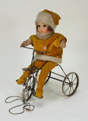 A Chad Valley Doll on Trike cloth doll, circa 1930,