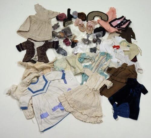 A collection of dolls clothes,