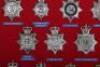 Fourteen Obsolete Police Queens Crown Helmet Plates - 2