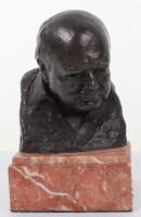 A Winston Churchill resin bust on marble base