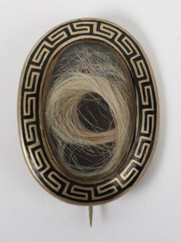 An 18th century gilt and enamel mourning brooch