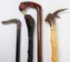 A group of walking canes and sticks, including a grotesque mask, - 3