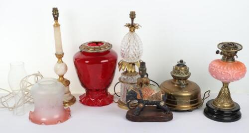 A good selection of table lamps, including two Victorian oil lamps with cranberry glass shades, one Lampe Veritas, with a French gilt brass and glass pineapple lamp (converted to electricity)