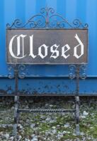 A vintage cast iron 'Closed' sign