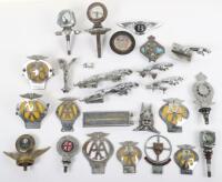 A selection of vintage automobile car badges and mascots