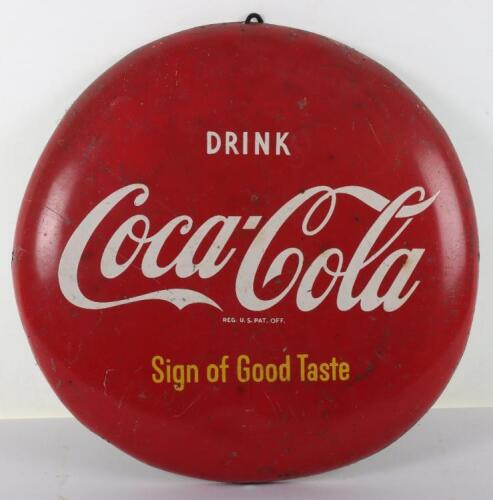 A Coca-Cola circular button sign ‘Drink Coca-Cola Sign of Good Taste’