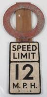 An original vintage aluminium Speed Limit 12M.P.H sign with wood board backing