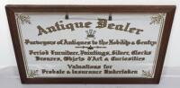 A mirrored sign ‘Antique Dealer Purveyor of Antiques to the Nobility & Gentry Period Furniture, Paintings, Silver, Clocks Bronzes, Objets d’Arts & Curiosities Valuations for Probate & Insurance Undertaken’