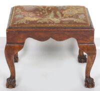 An 18th century walnut stool with ball and claw feet