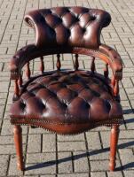 A 20th century leather and oak captains armchair