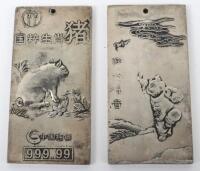 Two Chinese silver ingots depicting Year of the pig and another