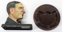 An Art Deco German tin plate cigarette dispenser of a gentleman in bow tie