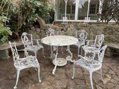 A set of six Coalbrookdale style iron painted chairs and table