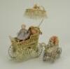 Two painted soft metal miniature carriages, German 1890s,