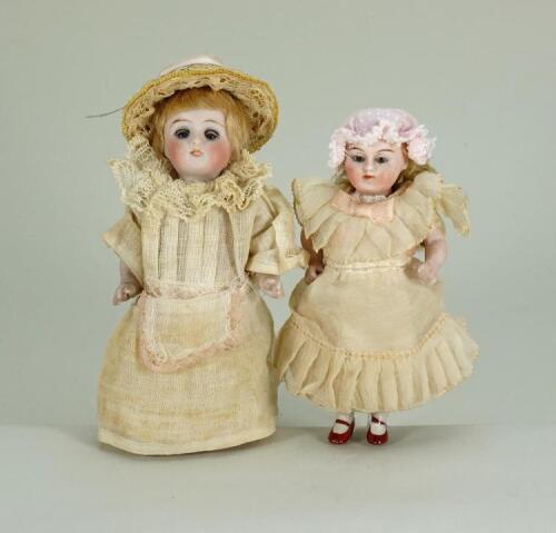 Pair of good all-bisque miniature dolls, German 1890s,