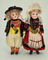 A pair of miniature bisque head dolls in regional costumes, German circa 1915,