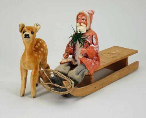 A composition headed Father Christmas on sledge, German circa 1900,