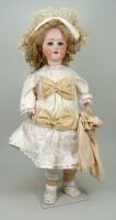 A Schoenau & Hoffmeister 1909 bisque head doll, German circa 1910,