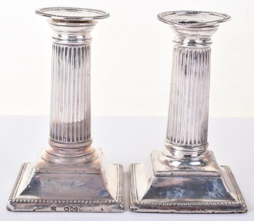 A pair of Victorian squat Corinthian column candlesticks, by William Hutton, London 1881