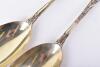 A fine pair of Victorian Bacchanalian pattern parcel gilt salad servers, by Henry John Lias & James Wakely, London 1880 - 4