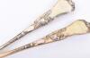 A fine pair of Victorian Bacchanalian pattern parcel gilt salad servers, by Henry John Lias & James Wakely, London 1880 - 6