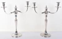 A pair of George III silver cast twin light candelabra, John Edwards, London 1795 and another maker