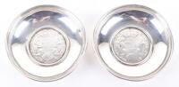 A pair of unmarked silver coin dishes