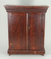 A sweet primitive stained wooden dolls cupboard, early 19th century,