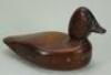 A carved and stained wooden decoy duck,