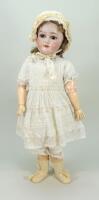 A Schoenau & Hoffmeister 1909 bisque head doll, German circa 1910,