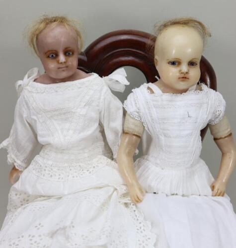 A pair of poured wax shoulder head dolls, English circa 1860,