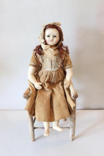 A small size wax over composition shoulder head doll, English circa 1850,