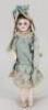 A small bisque head doll in original clothes, French circa 1890,