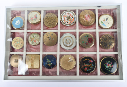 A collection of mid century compacts