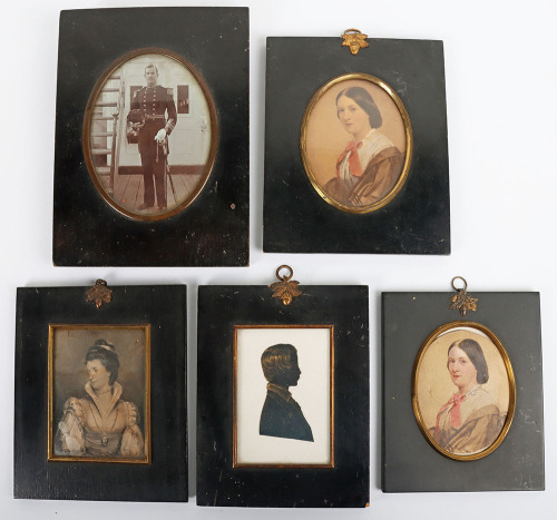 A 19th century silhouette portrait miniature of a boy, with two portrait miniatures of the same woman with red ribbon