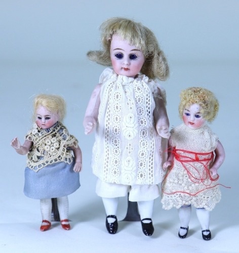 A miniature all-bisque doll and two others, German circa 1890,