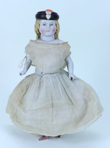 A rare Parian shoulder head doll with moulded hat, German 1860s,