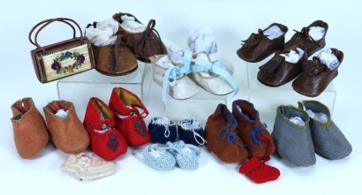 Eleven pairs of doll shoes,