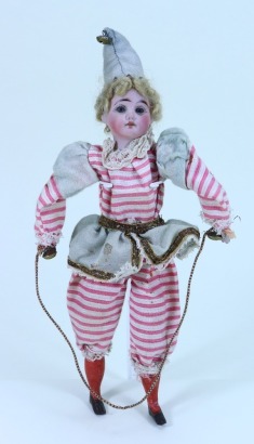 A bisque head clown squeak- toy doll in original clothes, French circa 1900,