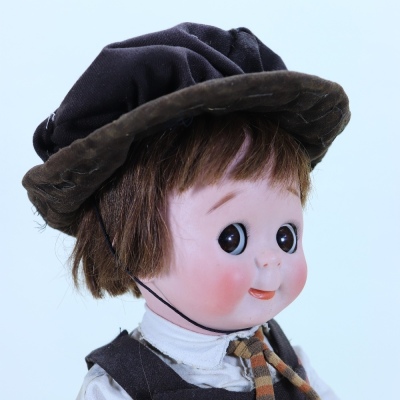 A rare large J.D Kestner 221 bisque head Googly doll in original school uniform, German circa 1911, - 2