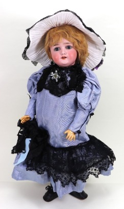 A Schoenau & Hoffmeister 1909 bisque head girl doll, German circa 1909,