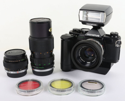 A Black Olympus OM-2 Spot/Program Camera and Lenses