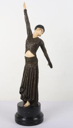 After Demetre Chiparus Footsteps, An Art Deco patinated resin and ivorine dancing lady