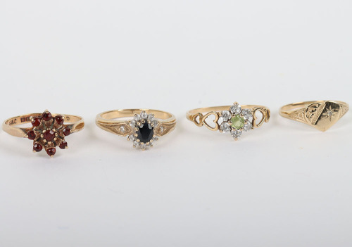 A group of four 9ct rings, including a 9ct ruby flower set ring, with a peridot and diamond ring, a sapphire and diamond ring and a 9ct signet ring,