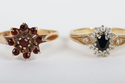 A group of four 9ct rings, including a 9ct ruby flower set ring, with a peridot and diamond ring, a sapphire and diamond ring and a 9ct signet ring, - 2